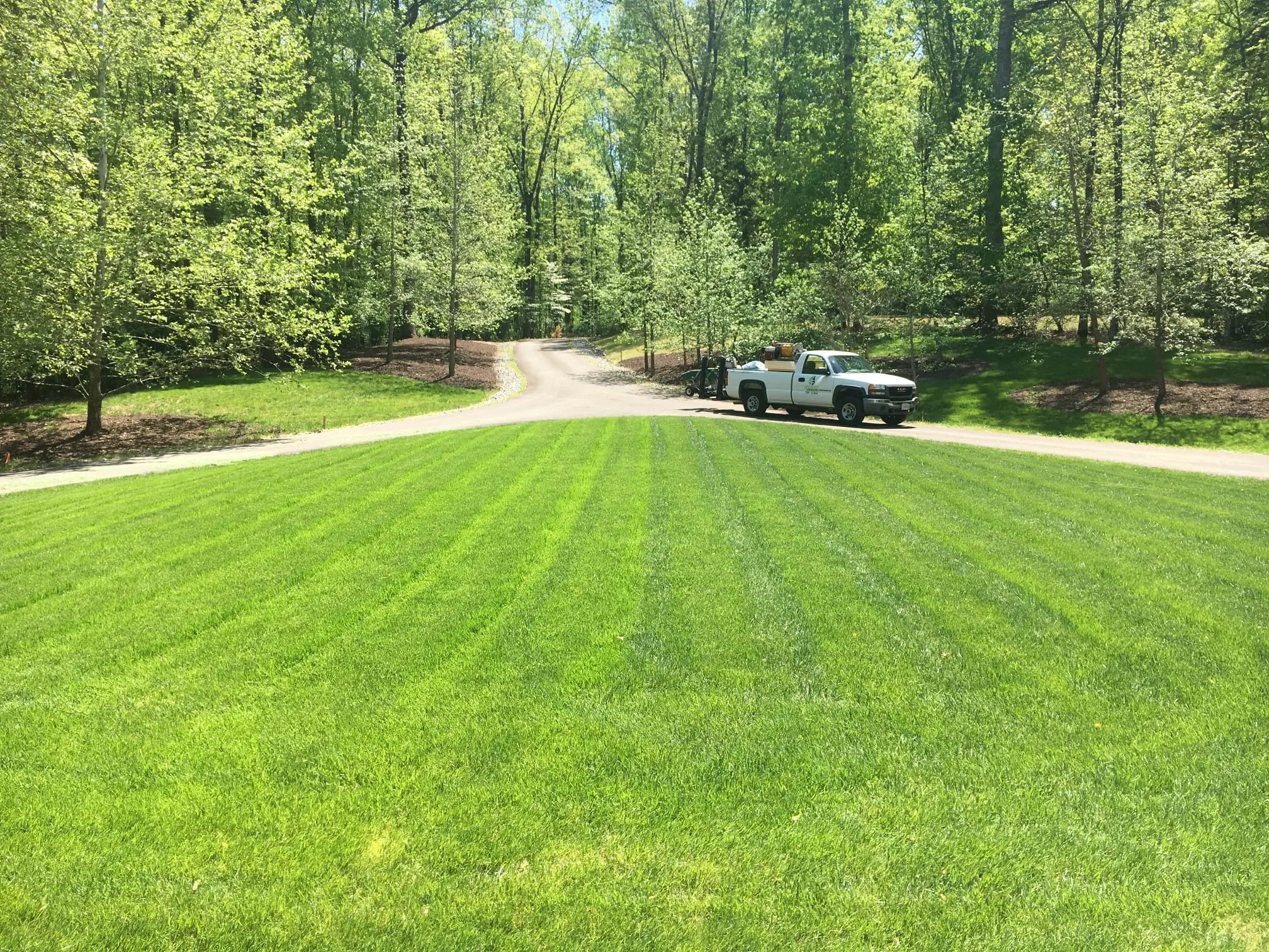 Lawn treatment being applied to a Richmond VA property through the seasons